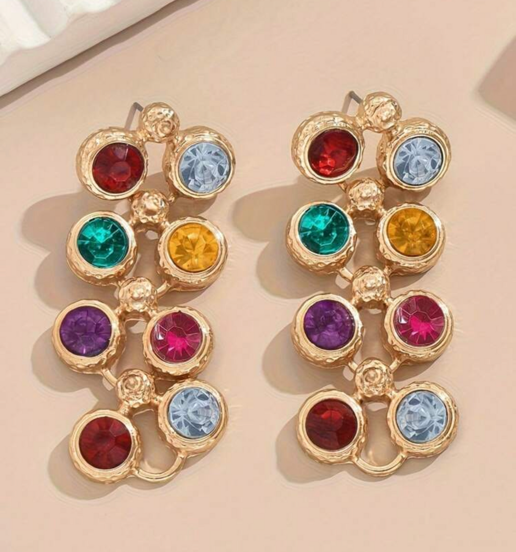 Multicolored gemstone earrings on a beige background