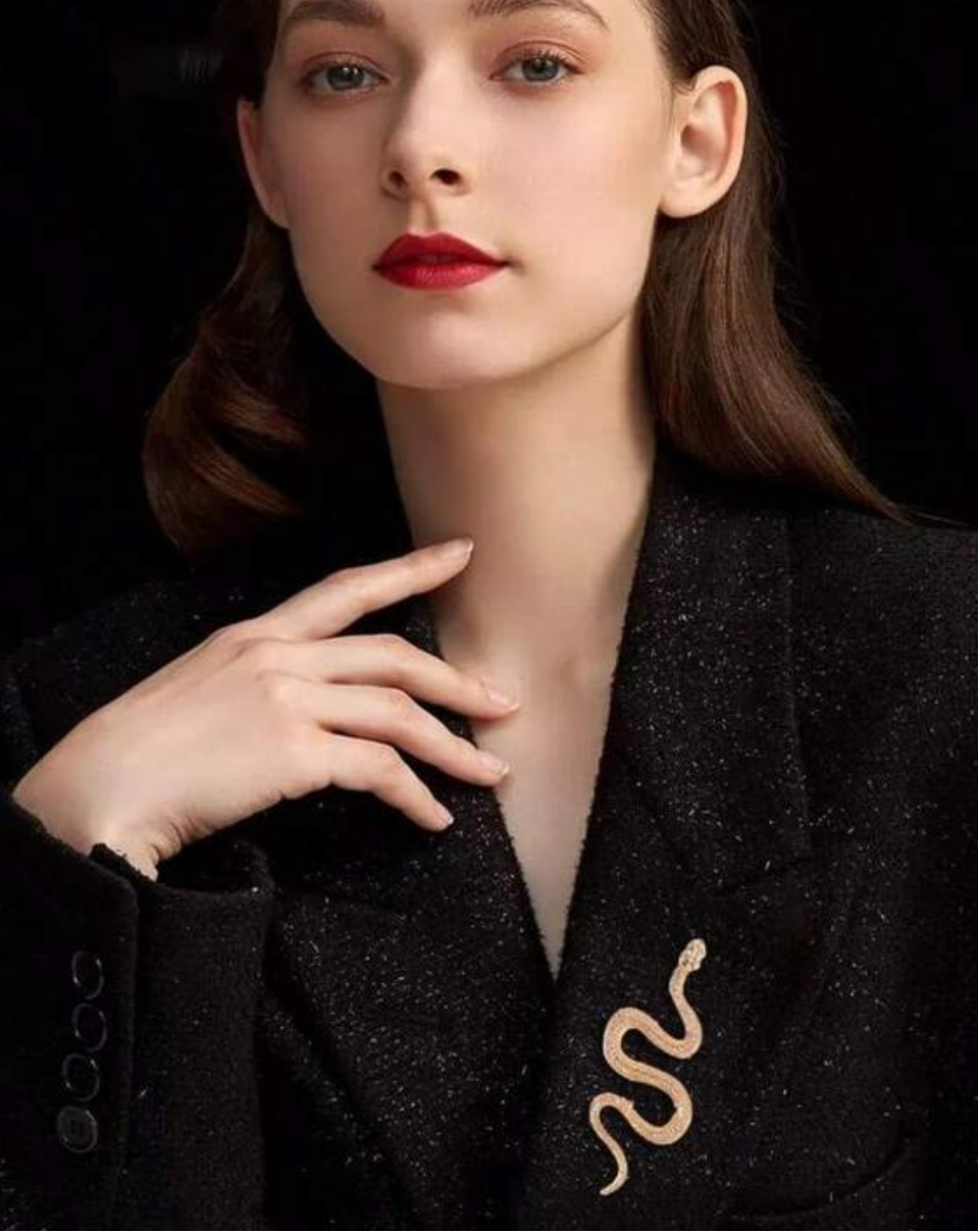 Woman wearing a black outfit with a gold emblem, promotional text at the bottom.