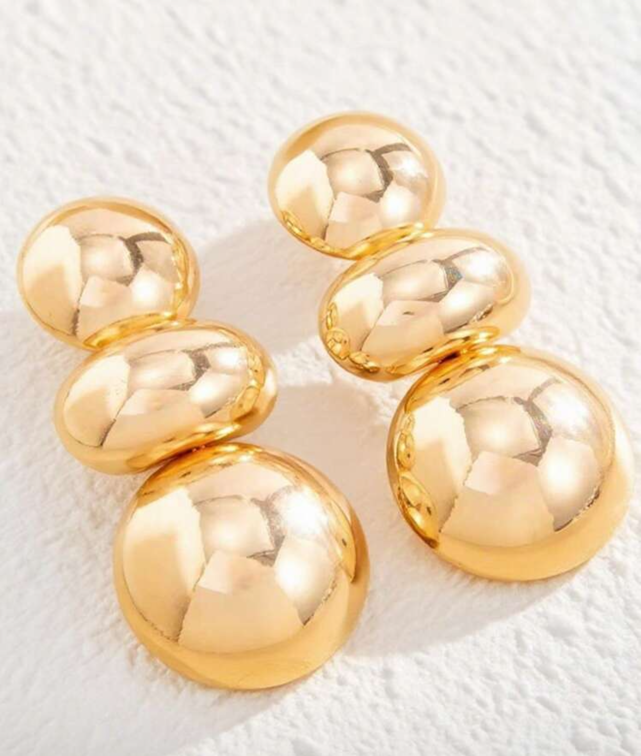 Gold stud earrings on a white background with product details below.
